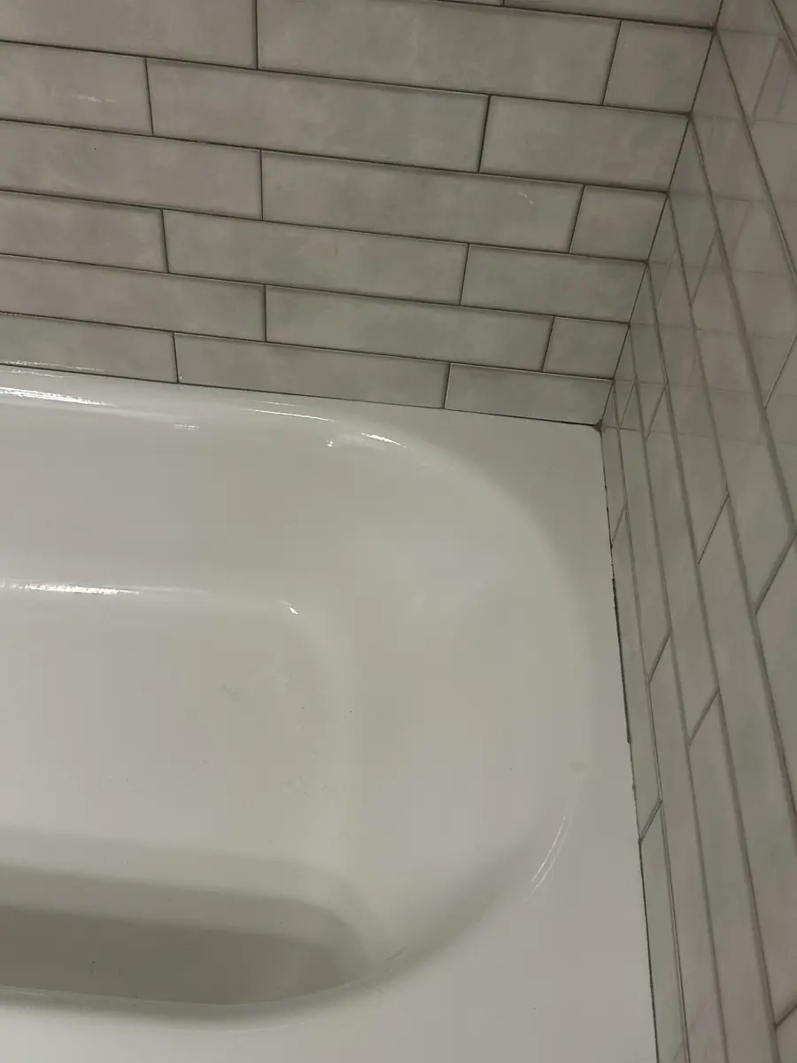 The same bathtub and tile corner clean, after